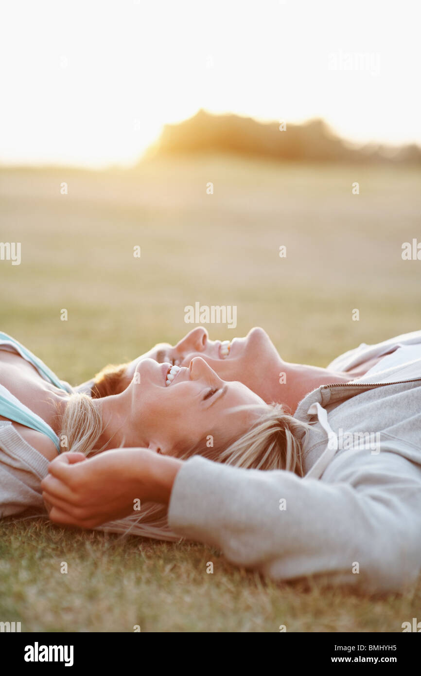 Couple relaxing on the grass Stock Photo - Alamy