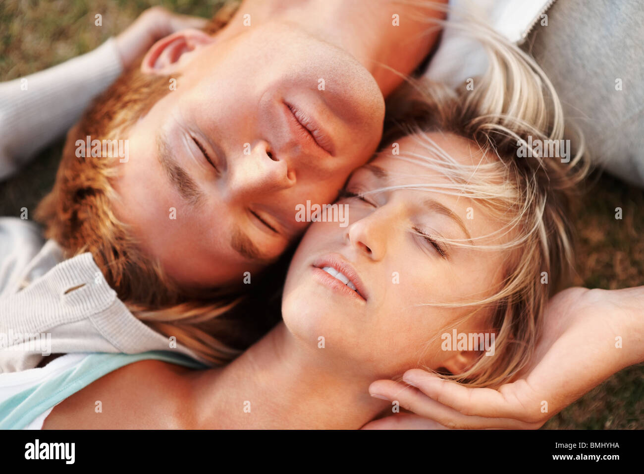 Couple relaxing on the grass Stock Photo - Alamy