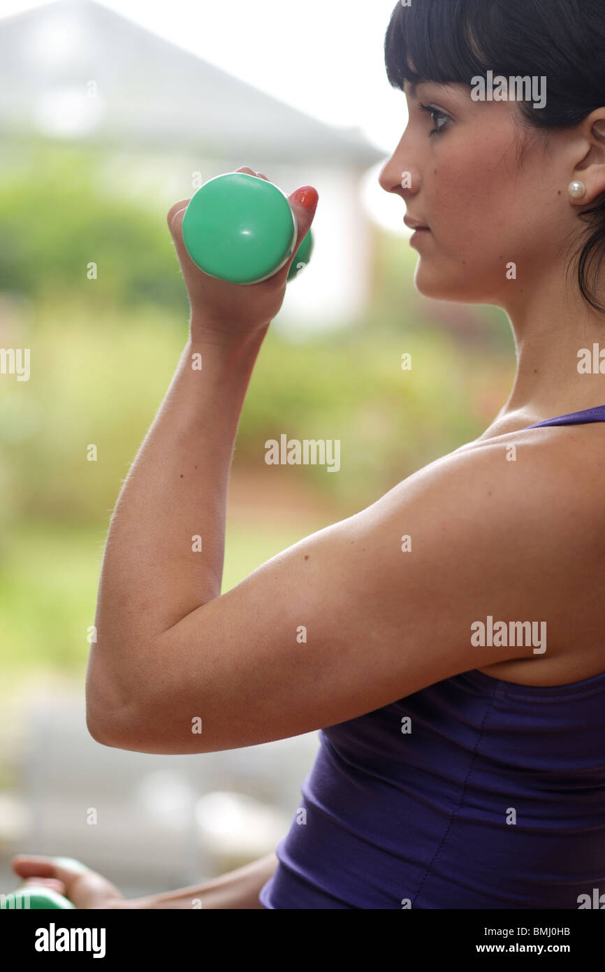 young Woman Using Dumb Bells. Model Released Stock Photo