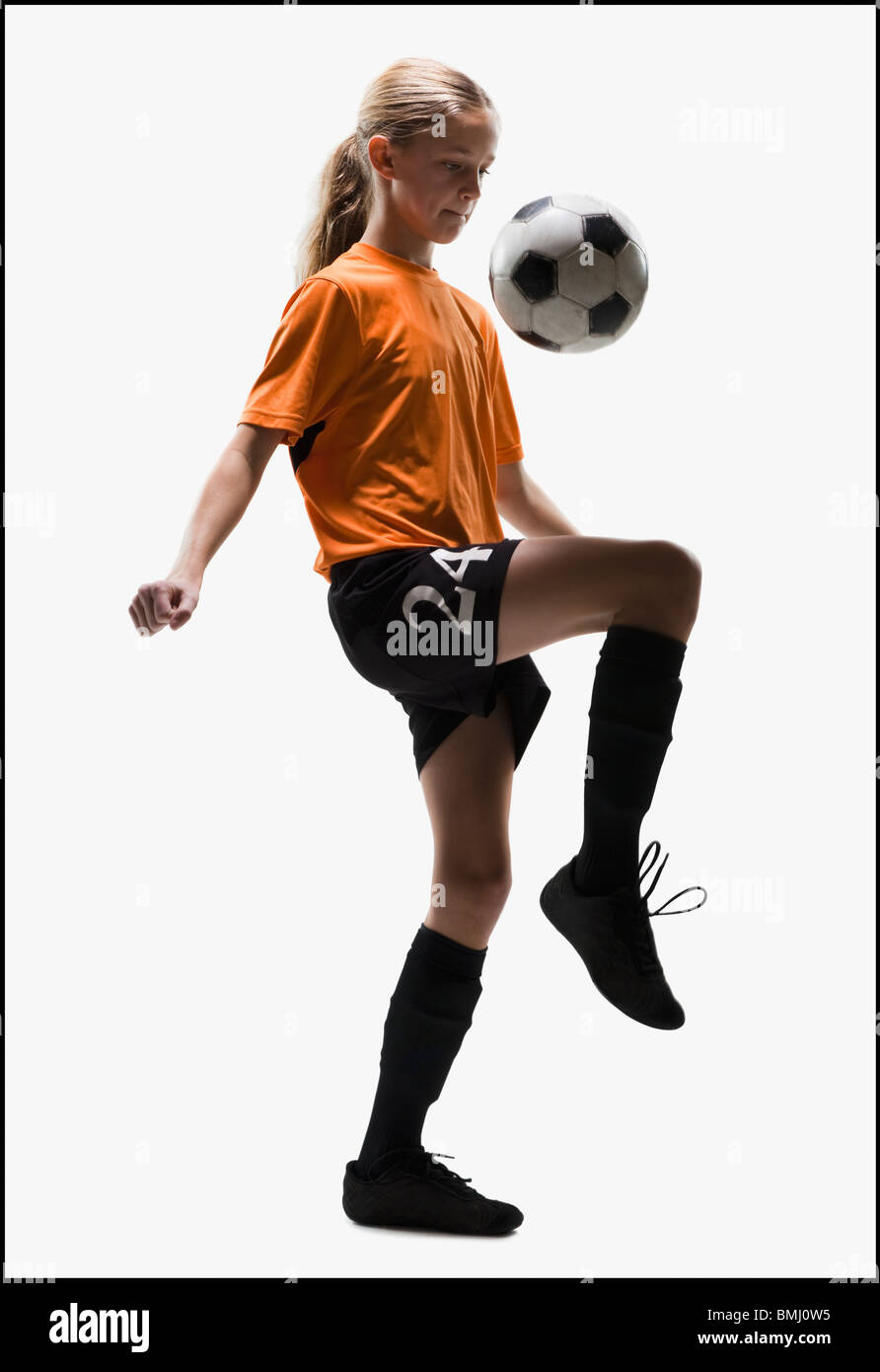 Girl dribbling soccer ball hires stock photography and images Alamy