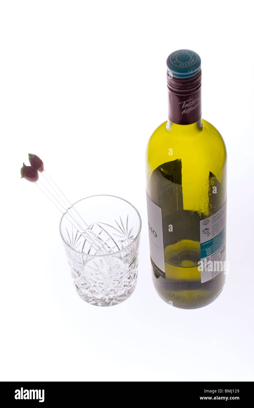 Cut glass with glass stirring sticks and wine bottle Stock Photo