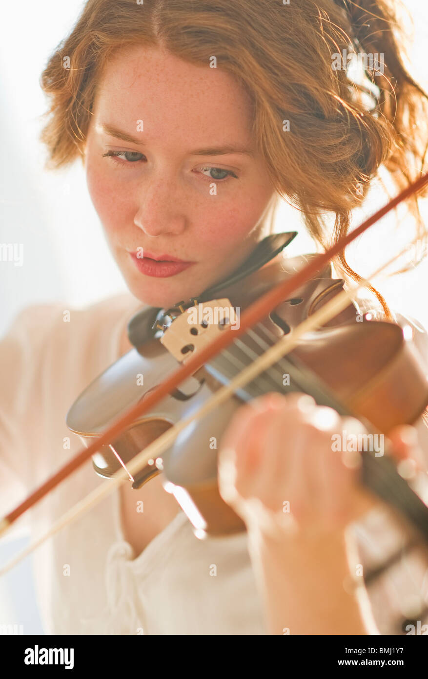 Woman playing violin Stock Photo
