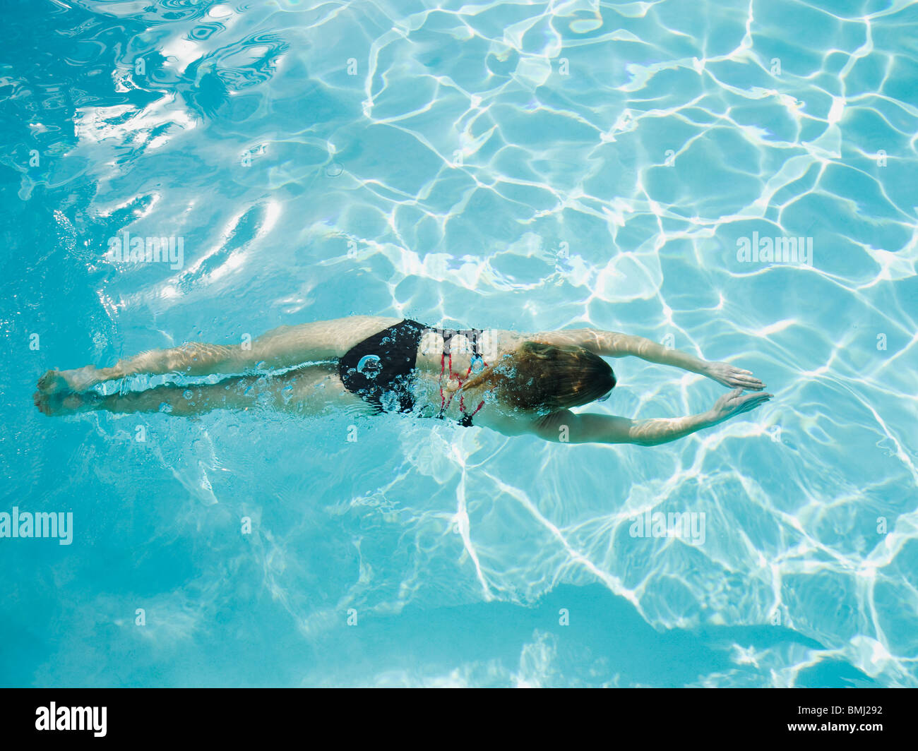Woman swimming in pool Stock Photo - Alamy