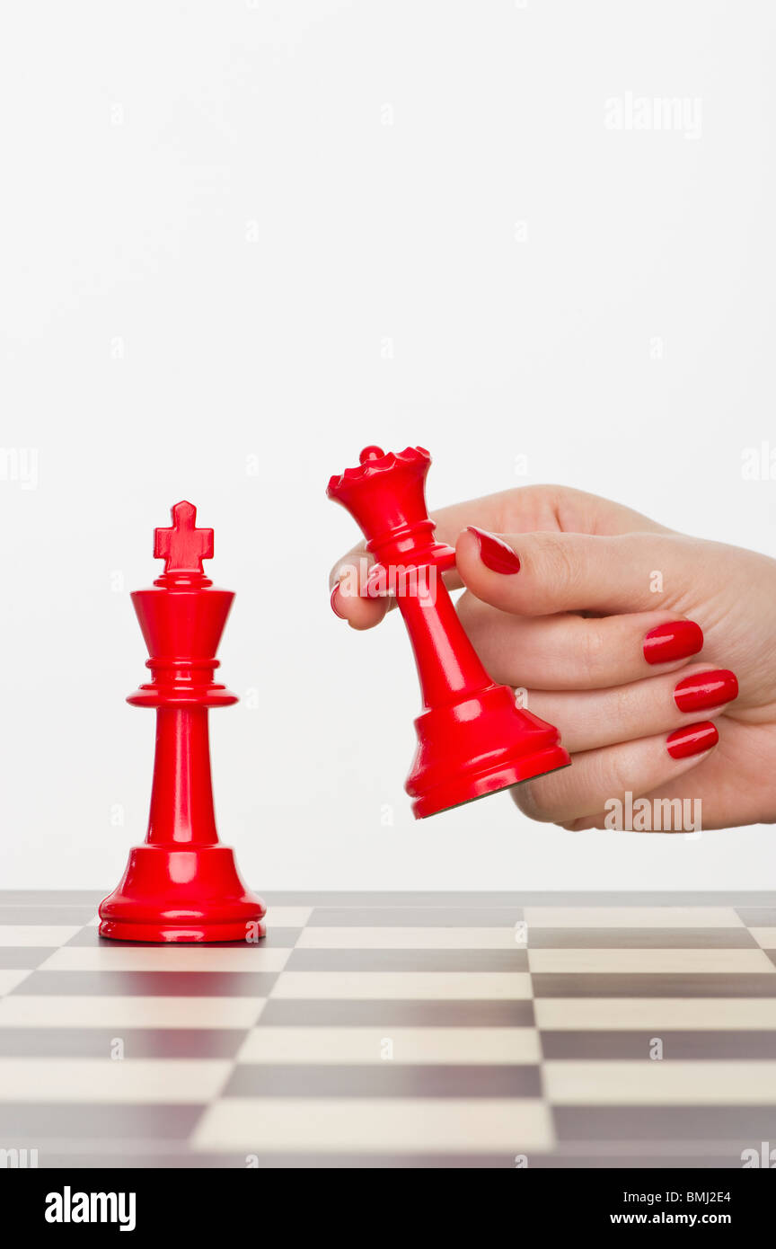 Hand holding red chess piece Stock Photo