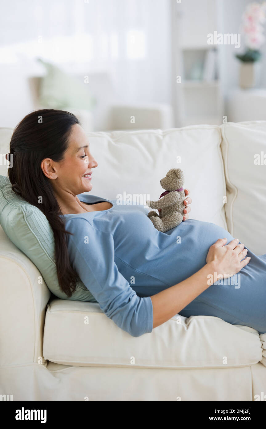 Pregnant woman resting on couch Stock Photo Alamy