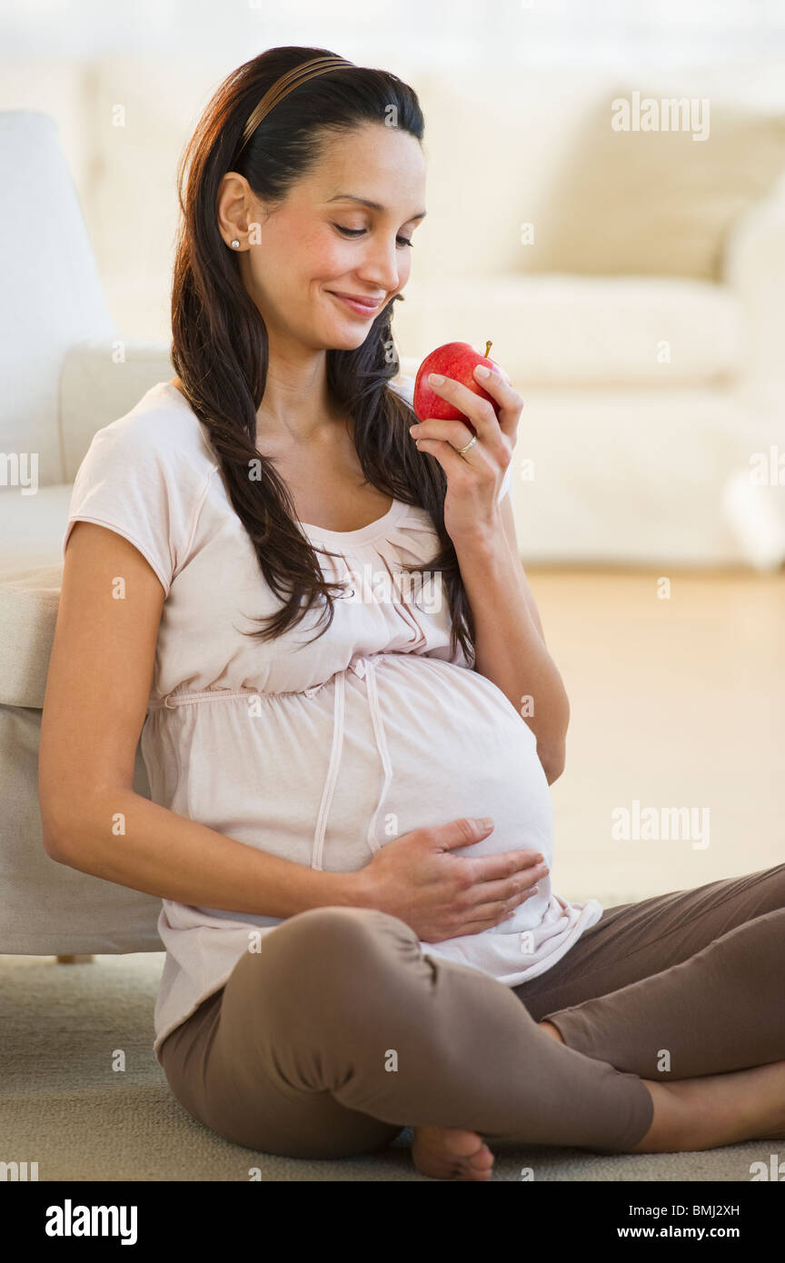 Pregnant woman eating an apple Stock Photo Alamy