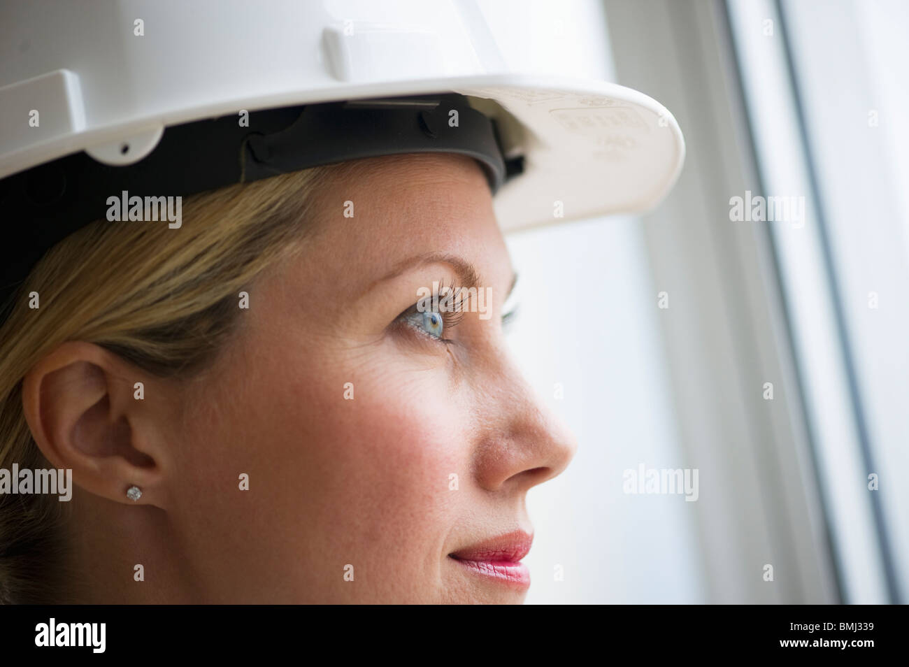 Female architect wearing a hard hat Stock Photo