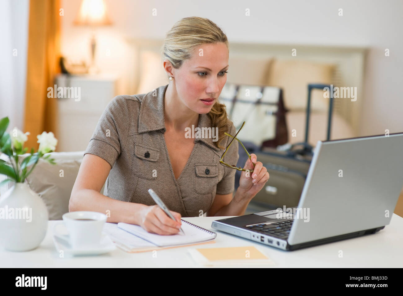 Woman working in hotel room Stock Photo