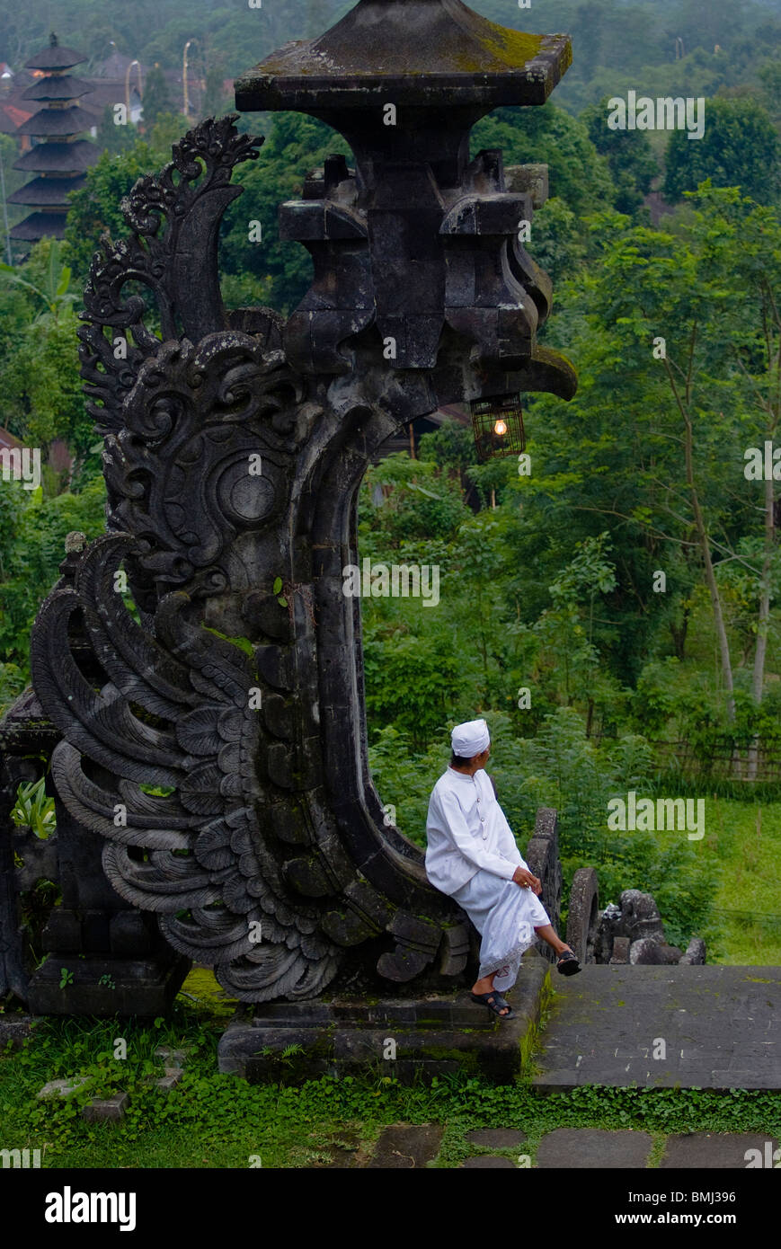 A Hindu holy man takes time for meditation at Pura Besakih, the Mother Temple also known as Pura Besakih in Bali, Indonesia. Stock Photo
