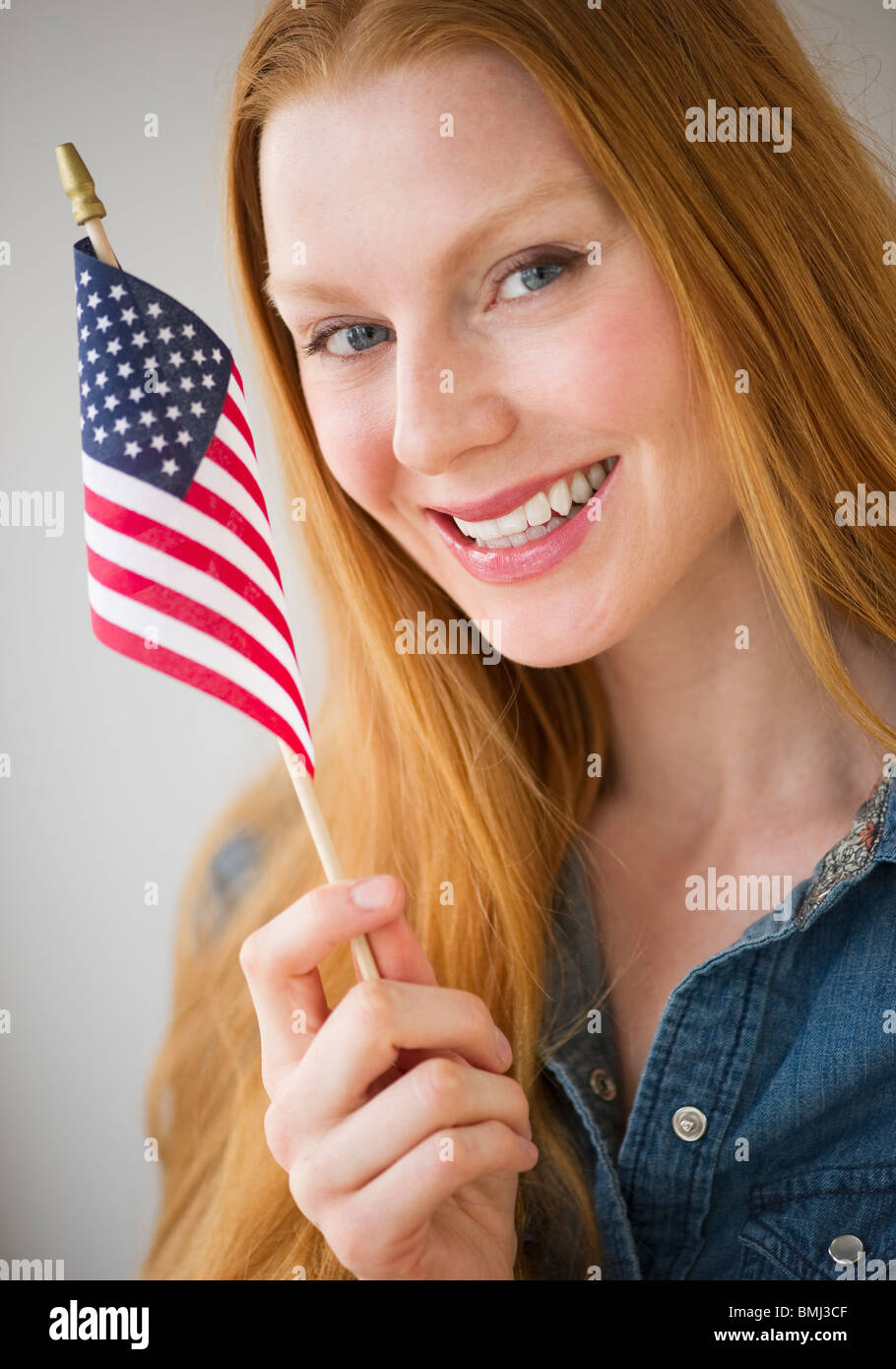 Woman holding American flag Stock Photo Alamy