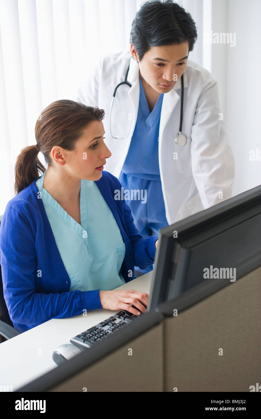 Doctor and nurse looking at computer Stock Photo