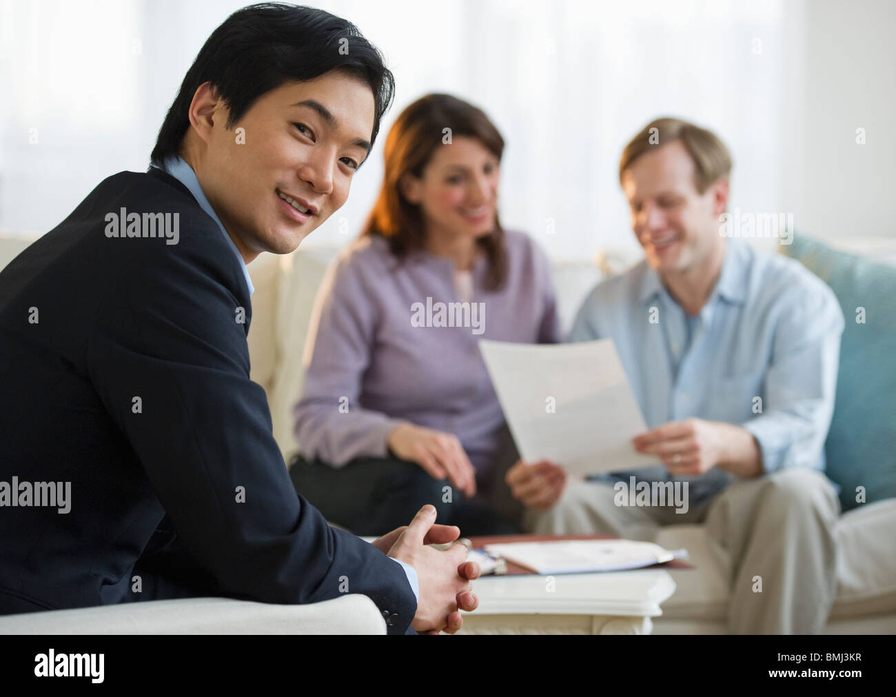 Financial planner and couple at home consultation Stock Photo