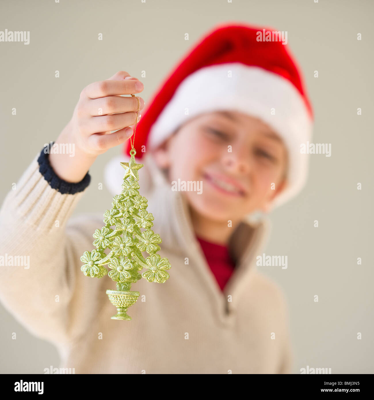 Young boy holding a Christmas ornament Stock Photo