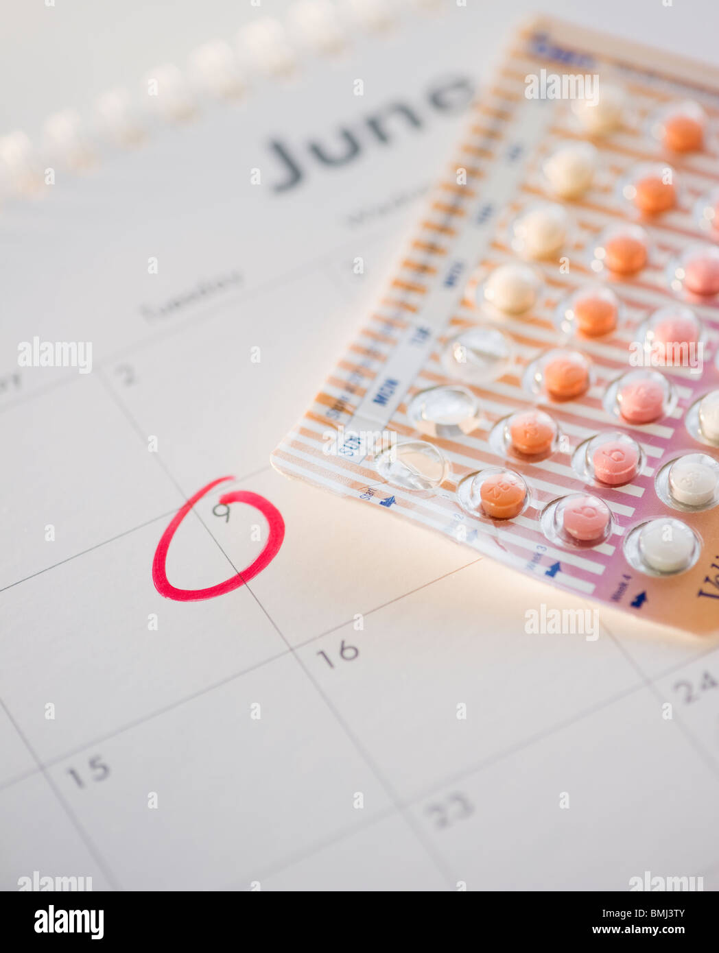 Birth control pills and calendar Stock Photo