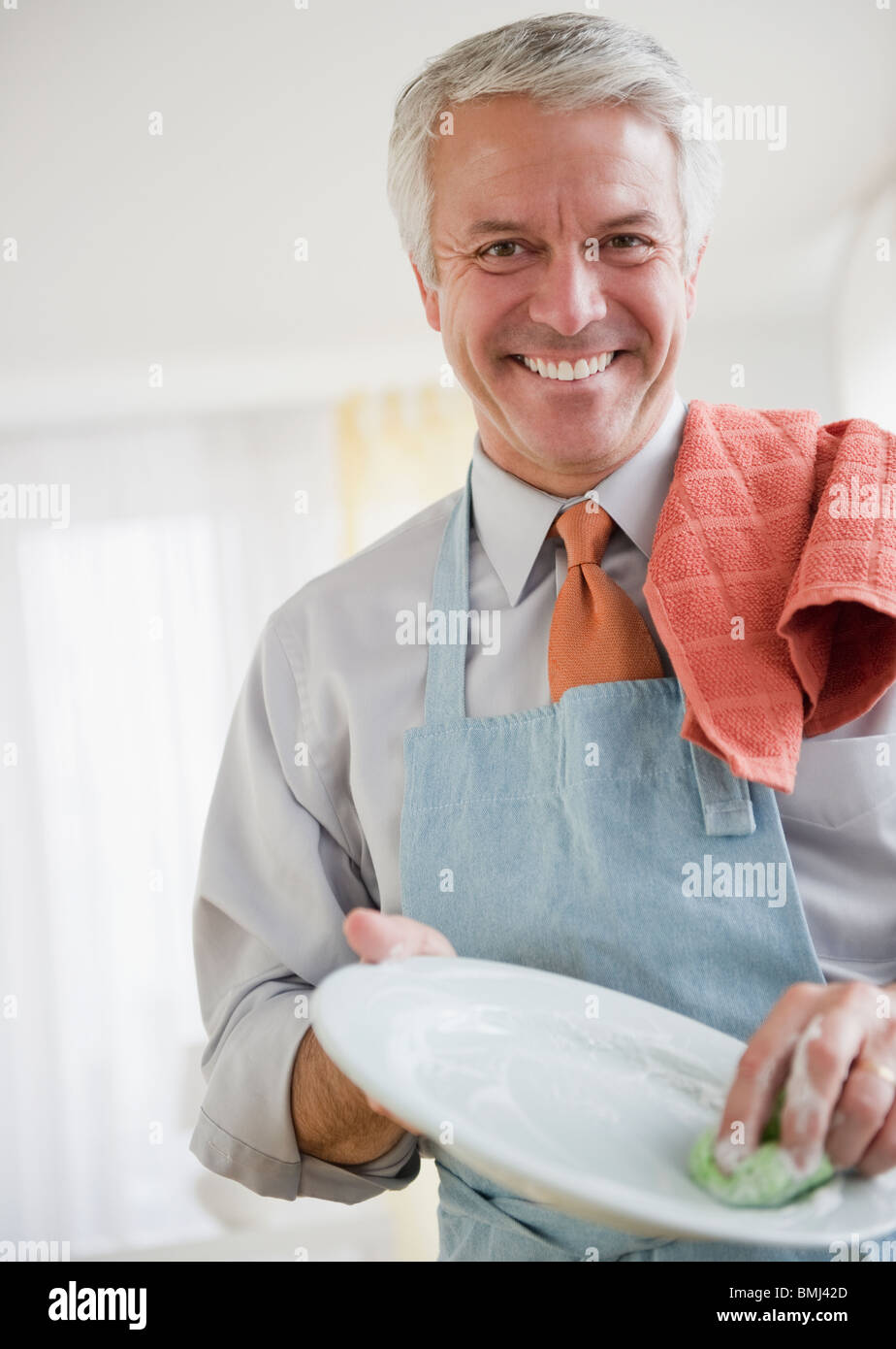 Father washing dishes Stock Photo