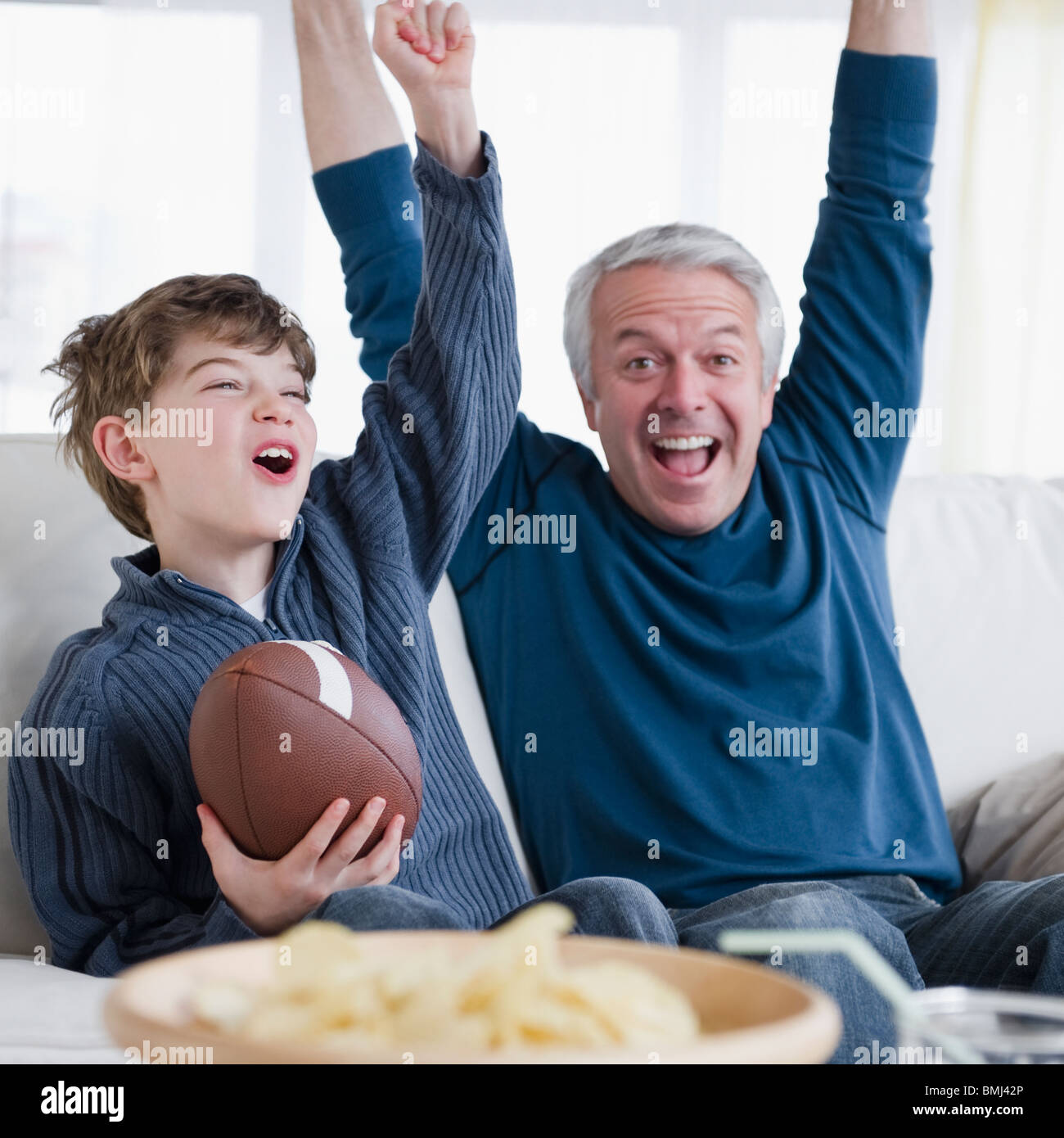 Father and son watching football game Stock Photo Alamy