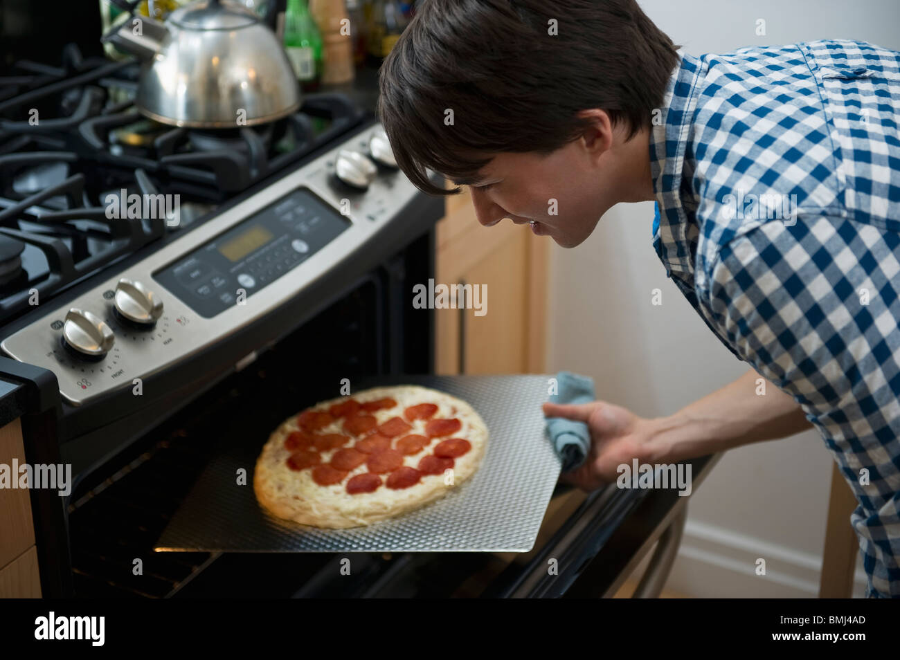 Man cooking pizza Stock Photo