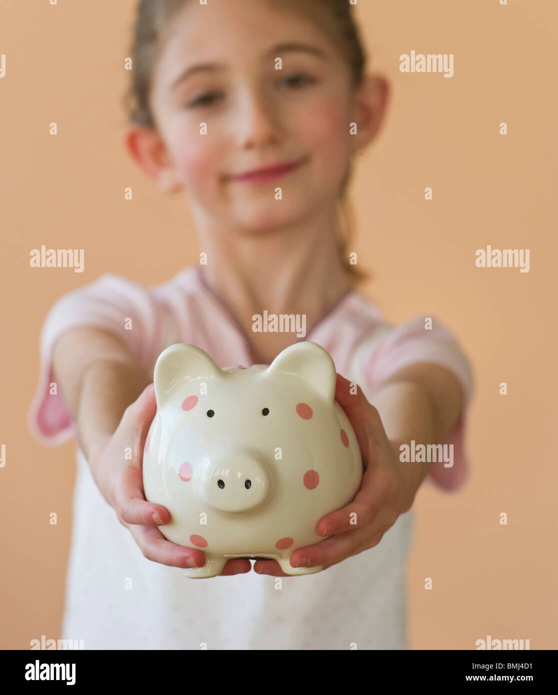 Young girl holding a piggy bank Stock Photo - Alamy