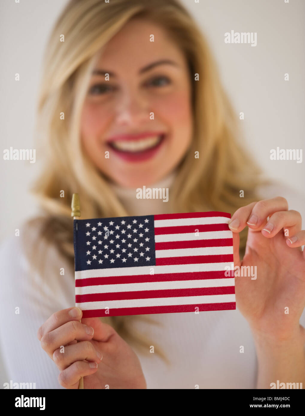 Young woman holding American flag Stock Photo Alamy