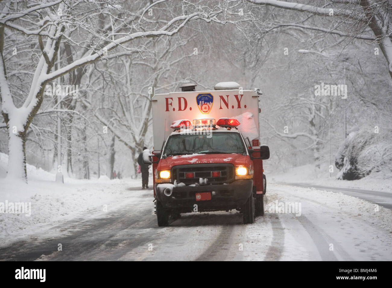 New York City fire department vehicle driving on snowy road Stock Photo