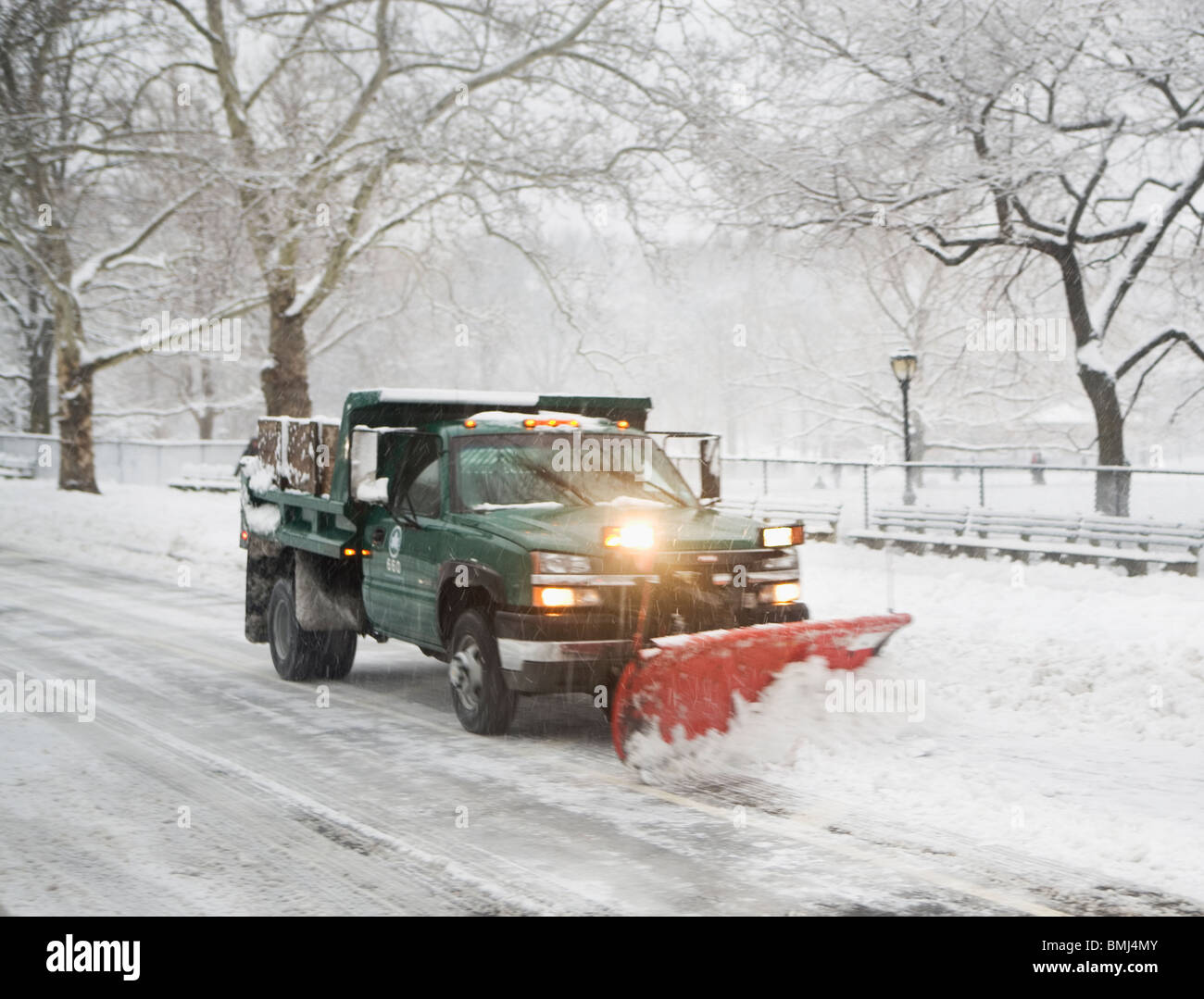 Snow plow truck clearing road Stock Photo