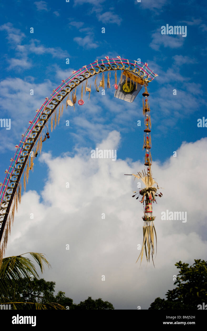 Long decorative bamboo poles, locally known as 'penjor' constructed when Balinese Hindus celebrate Galungan and Kuningan Day. Stock Photo