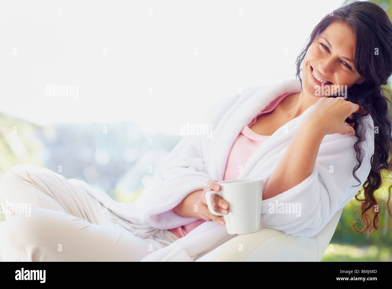 Woman in bathrobe drinking coffee Stock Photo Alamy