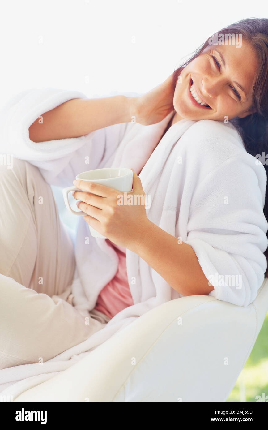 Woman in bathrobe drinking coffee Stock Photo Alamy