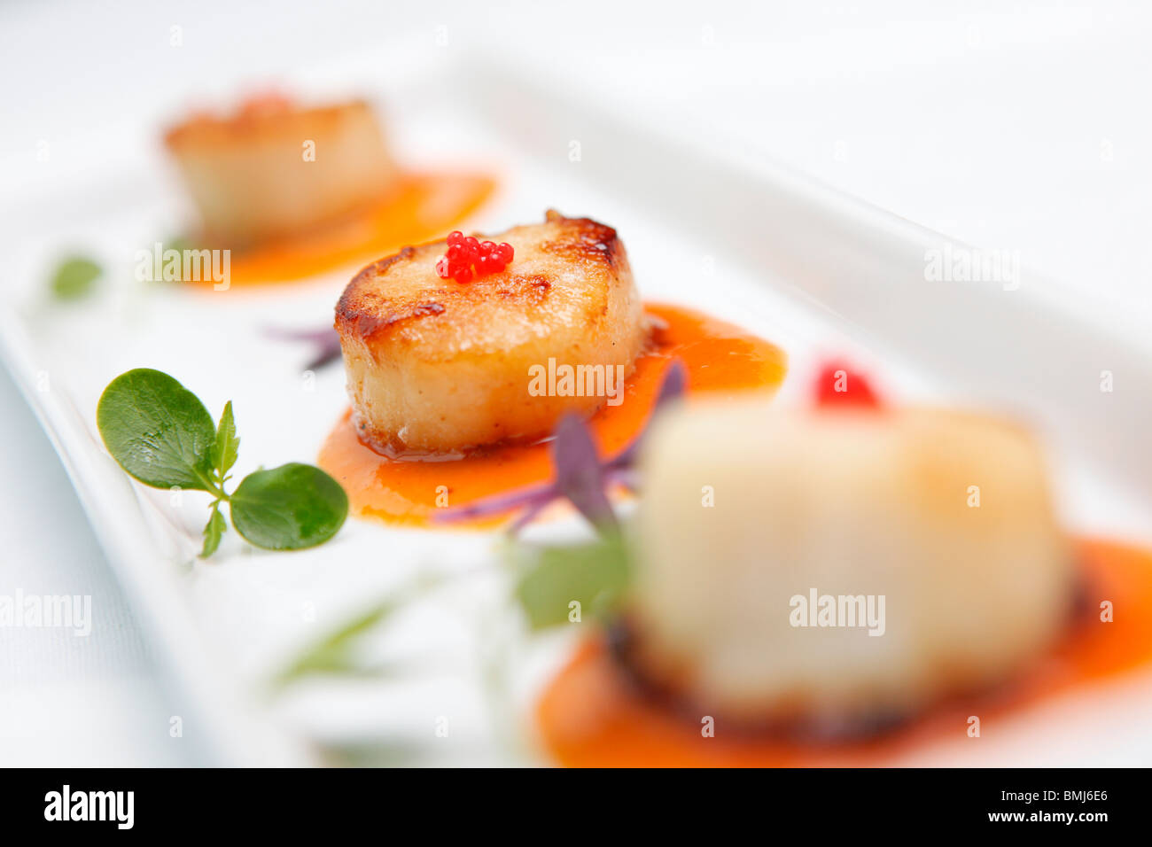 Scallops served in a tomato sauce, Mezze style, in a restaurant Stock Photo