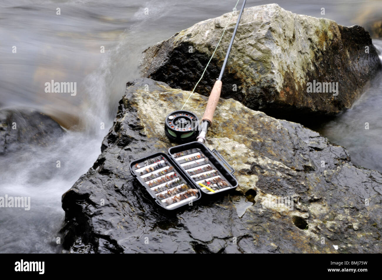 Fly fishing rod and reel and fishing box on rock Ribnik Bosnia and Herzegovina Stock Photo