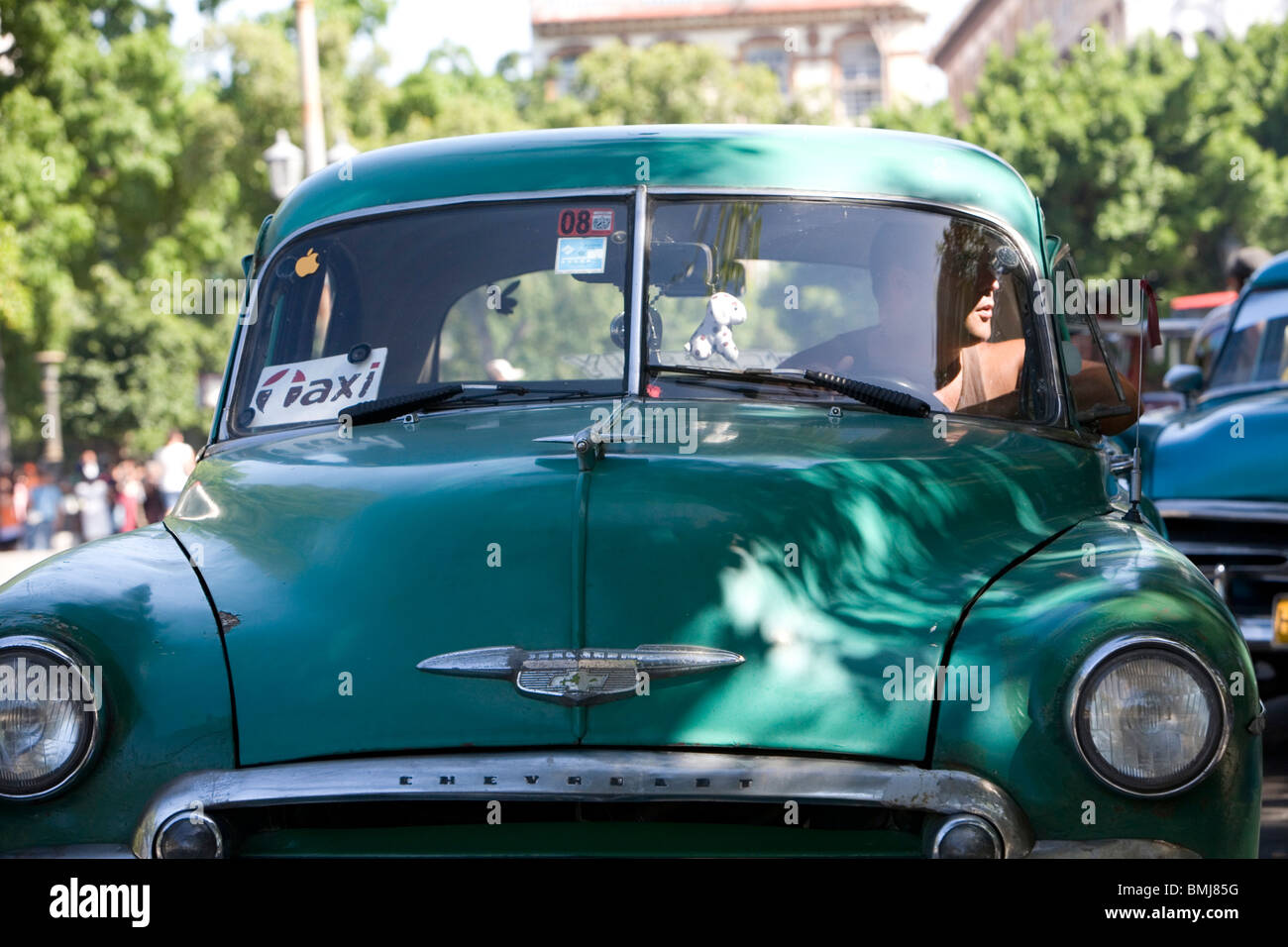 Classic American cars drive the streets of Havana, Cuba. Stock Photo