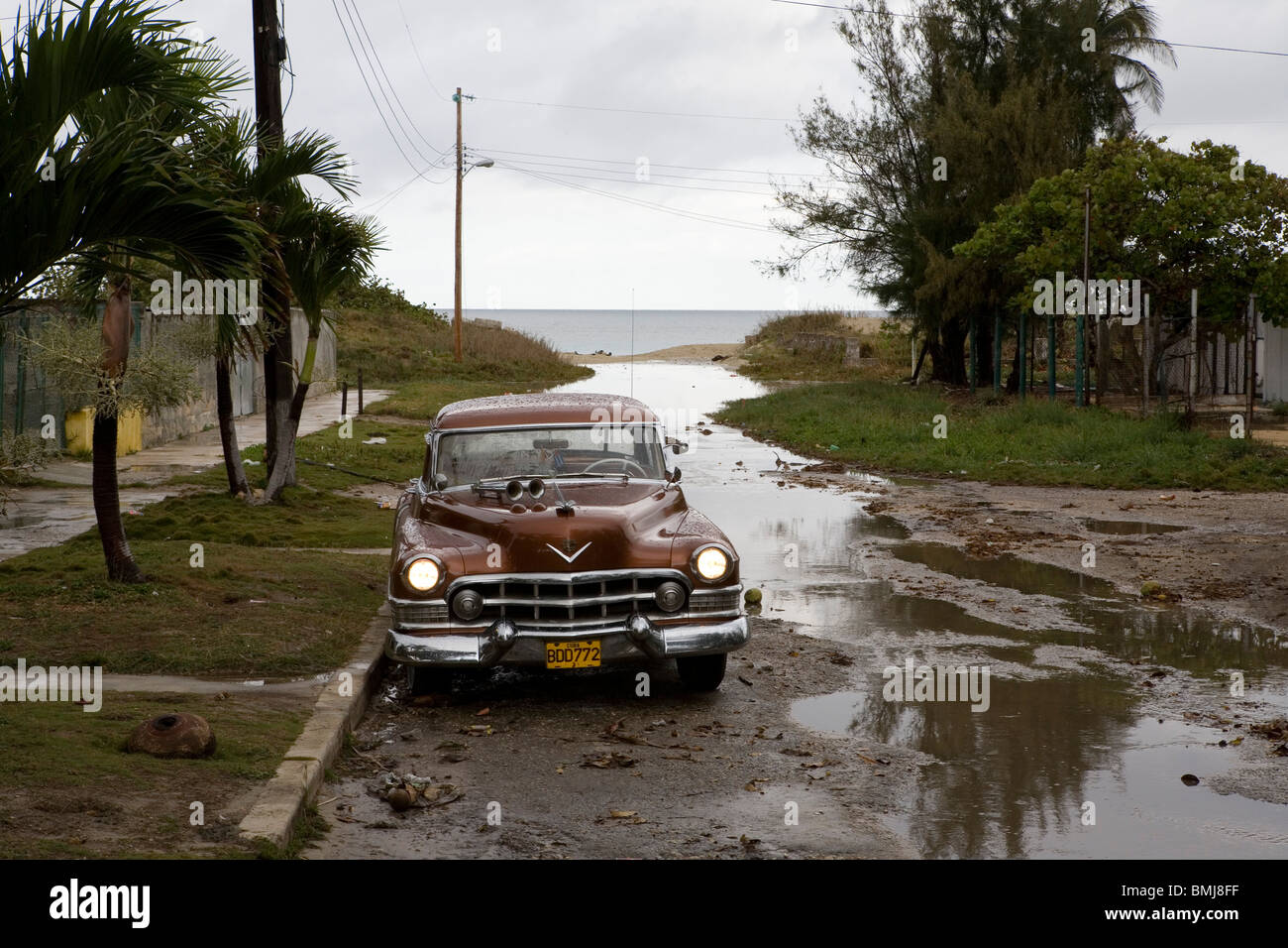 Classic American car during a rain storm in Guanabo along the Playas del Este, Cuba Stock Photo