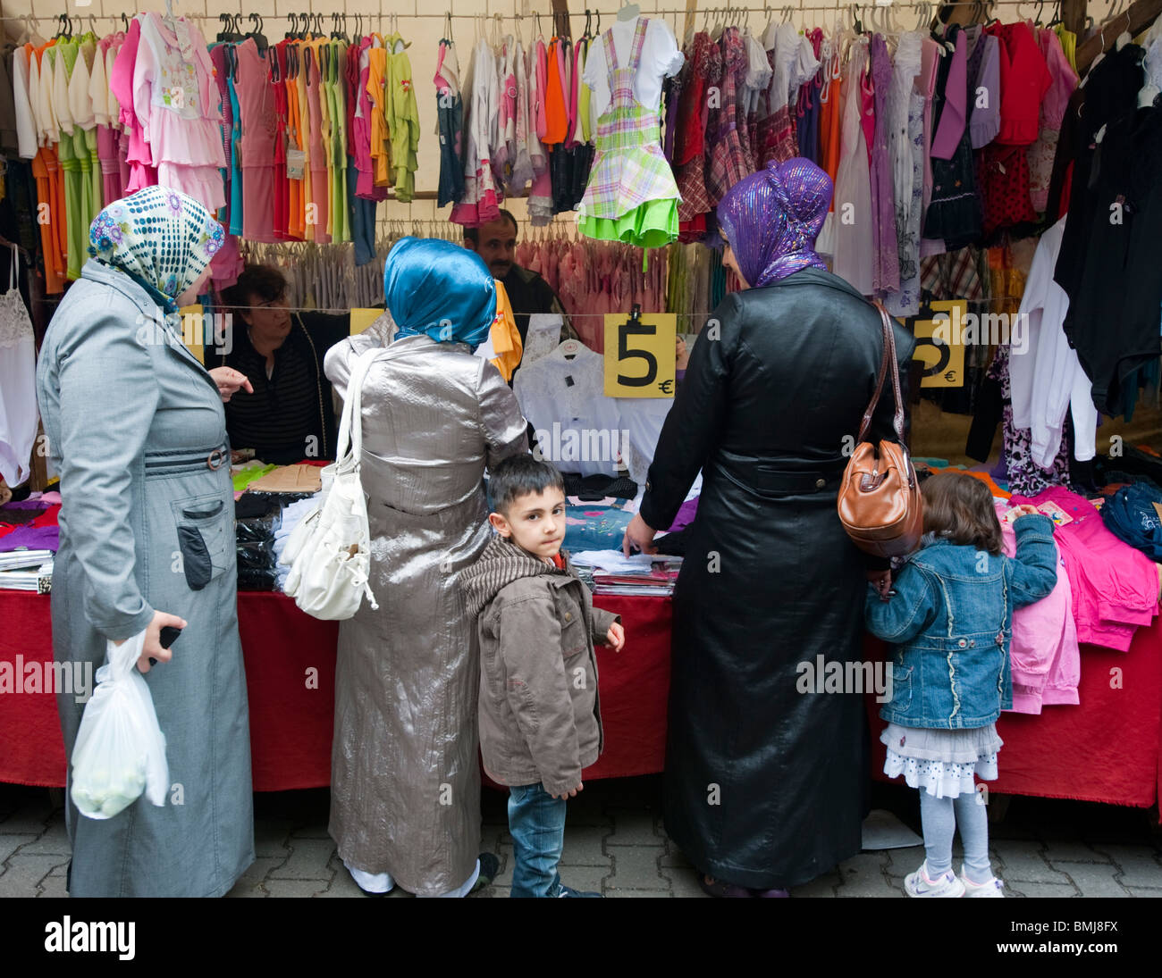 Turkish women buying headscarves at Turkish market on Maybachufer in Kreuzberg district of Berlin Germany Stock Photo