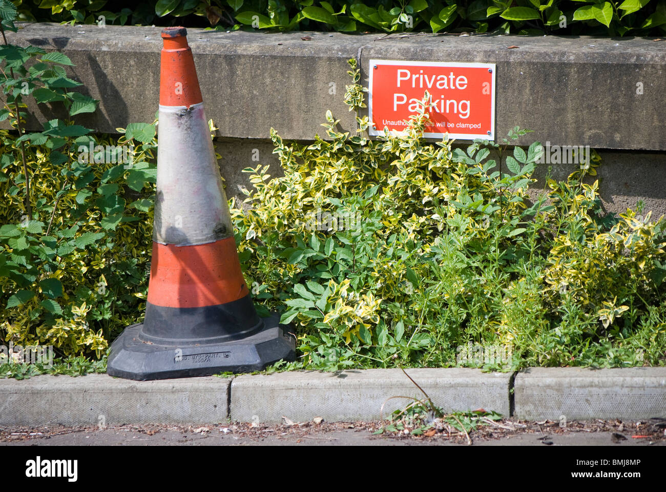 Parking cone and sign marking a private parking space in the centre of