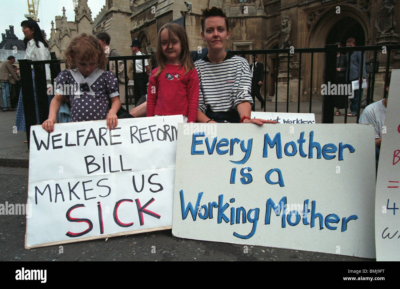 Mother with daughters protesting against welfare benefit reforms Westminster England Stock Photo