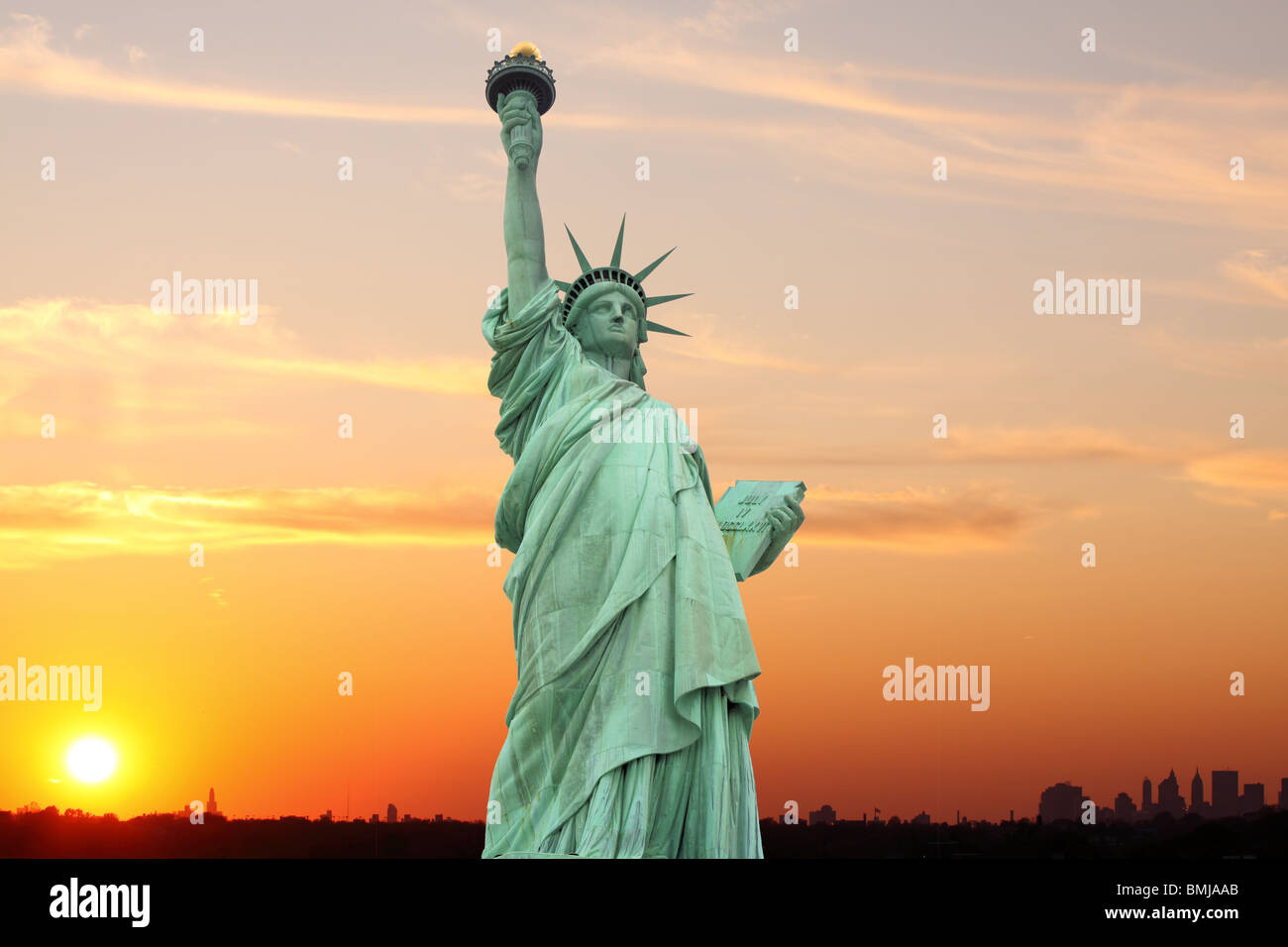 The Statue of Liberty and Manhattan skyline at sunset, New York City ...