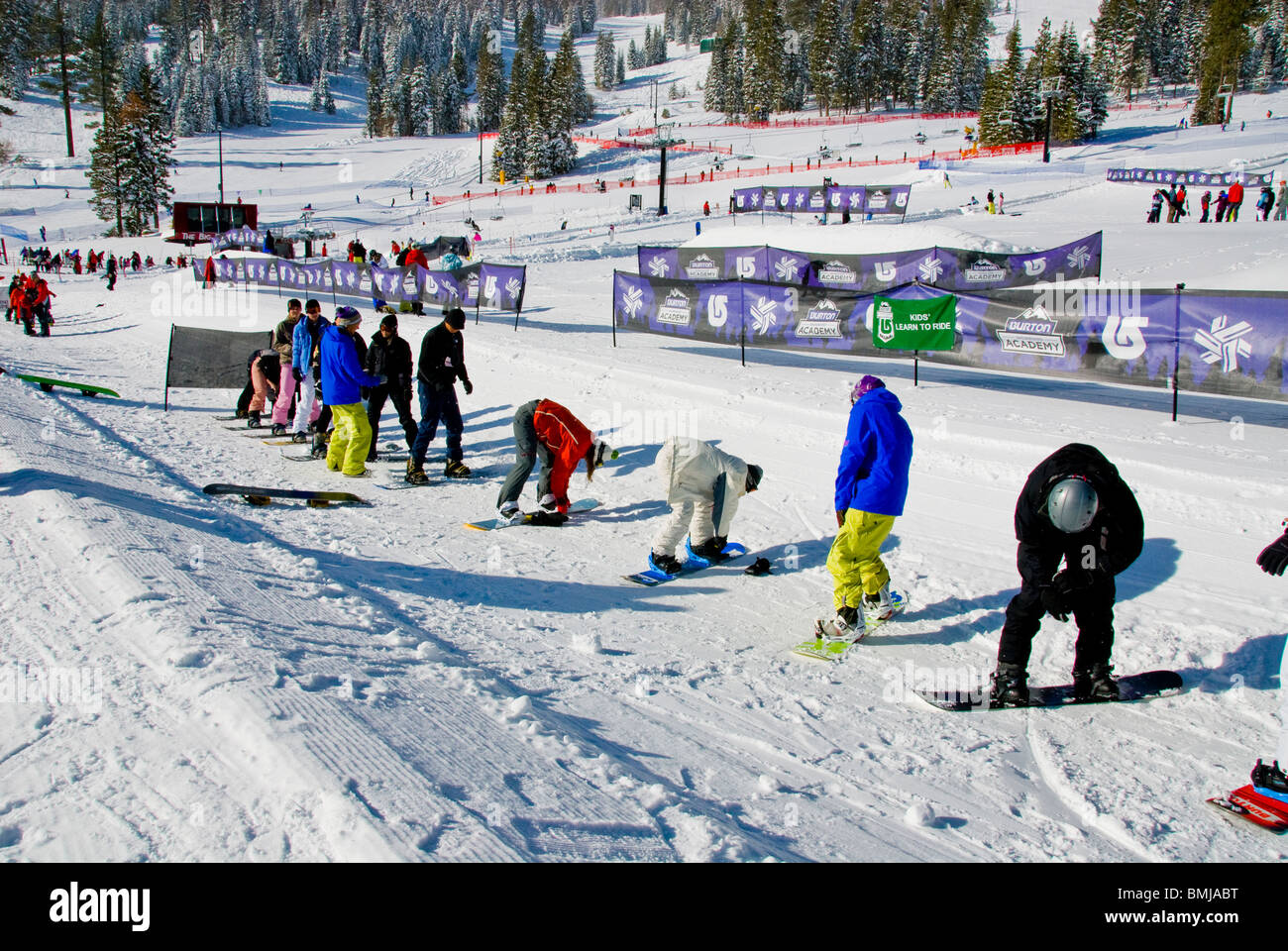 Winter scene Beginners ski and snowboard lessons snowboards skis Northstar Village Resort North Lake Tahoe California USA ice Stock Photo