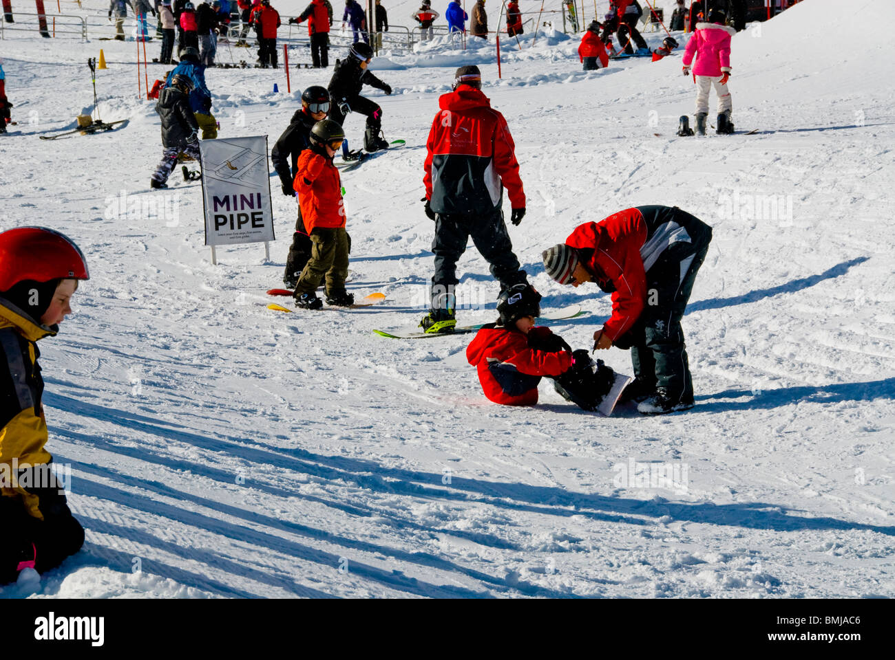 Winter scene Beginners ski and snowboard lessons snowboards skis Northstar Village Resort North Lake Tahoe California USA ice Stock Photo