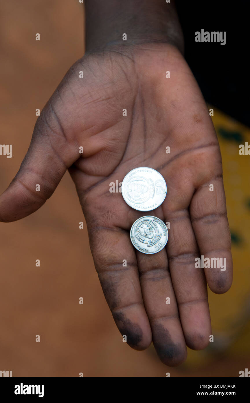 Hand with coins in. Rwanda. Stock Photo