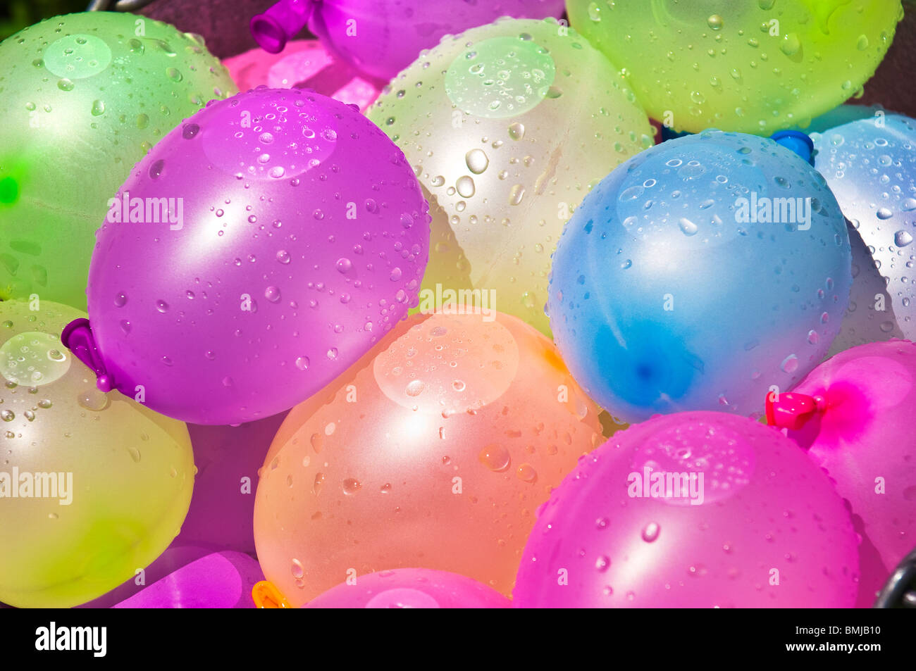 bucket full of colorful water balloons ready for battle close up Stock Photo