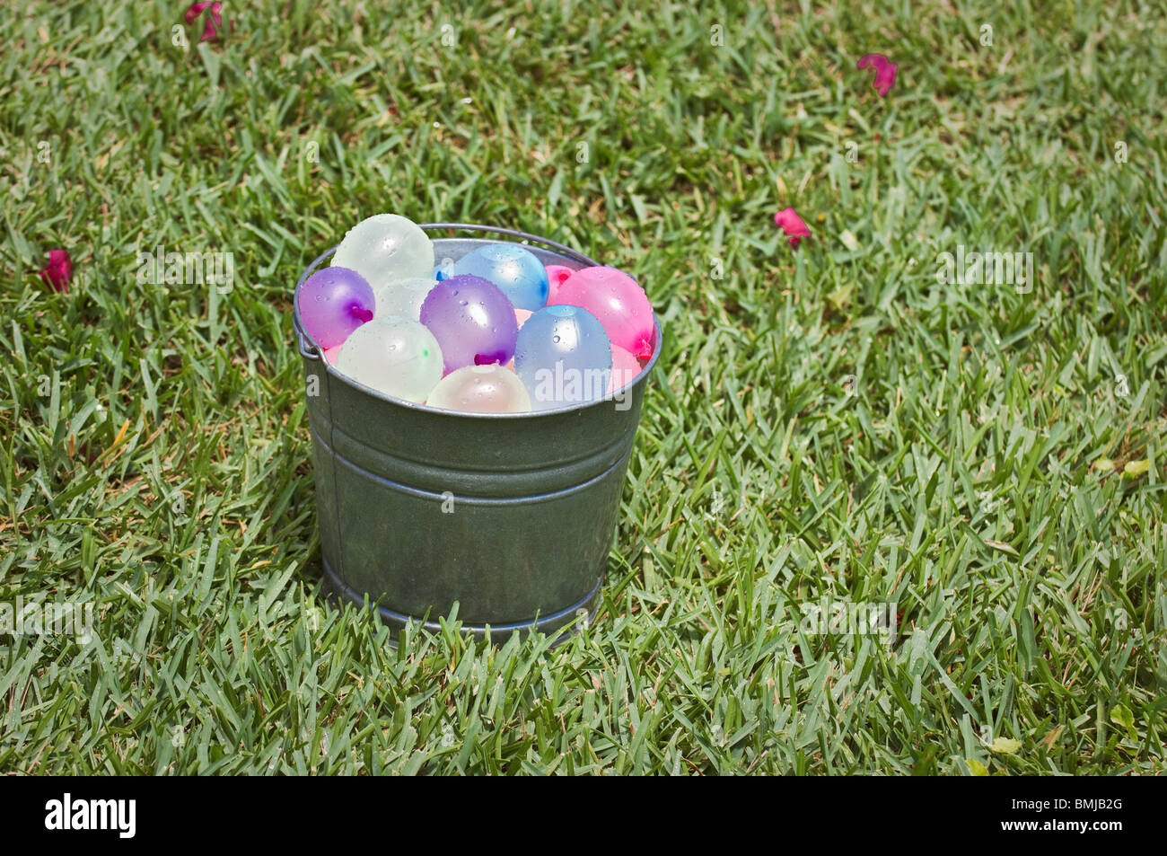 bucket full of colorful water balloons ready for battle Stock Photo