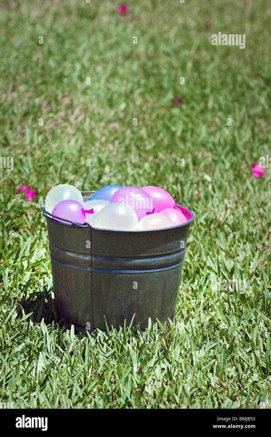 bucket full of colorful water balloons ready for battle Stock Photo