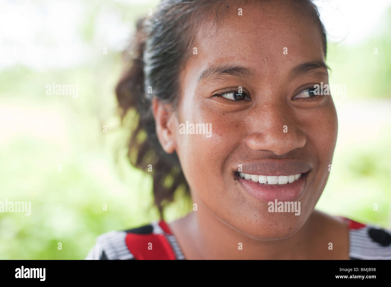 A young Marshallese woman smiles for the camera, Jaluit Atoll Stock