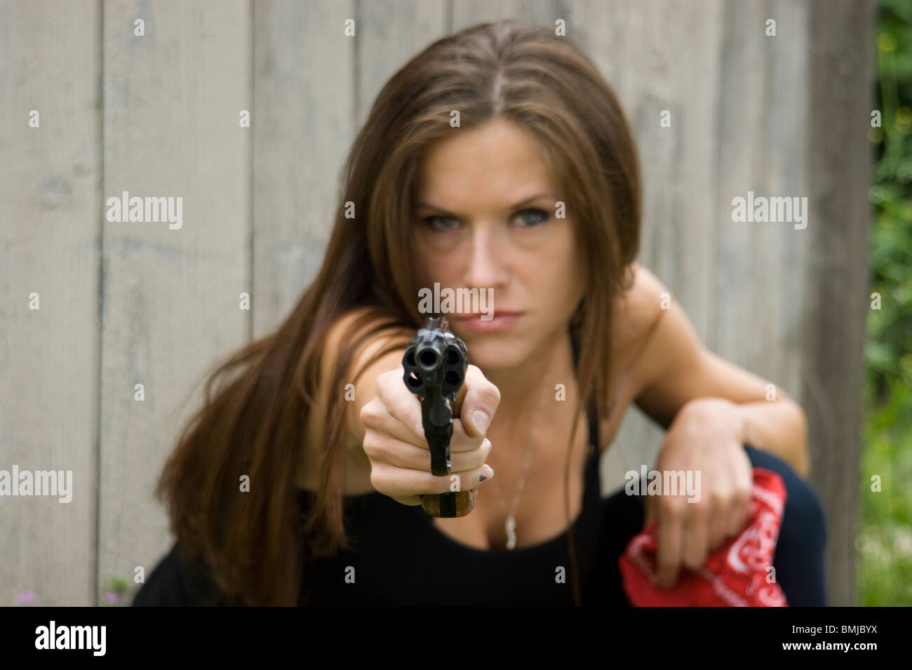 Beautiful Woman holds 38 Special Revolver Stock Photo