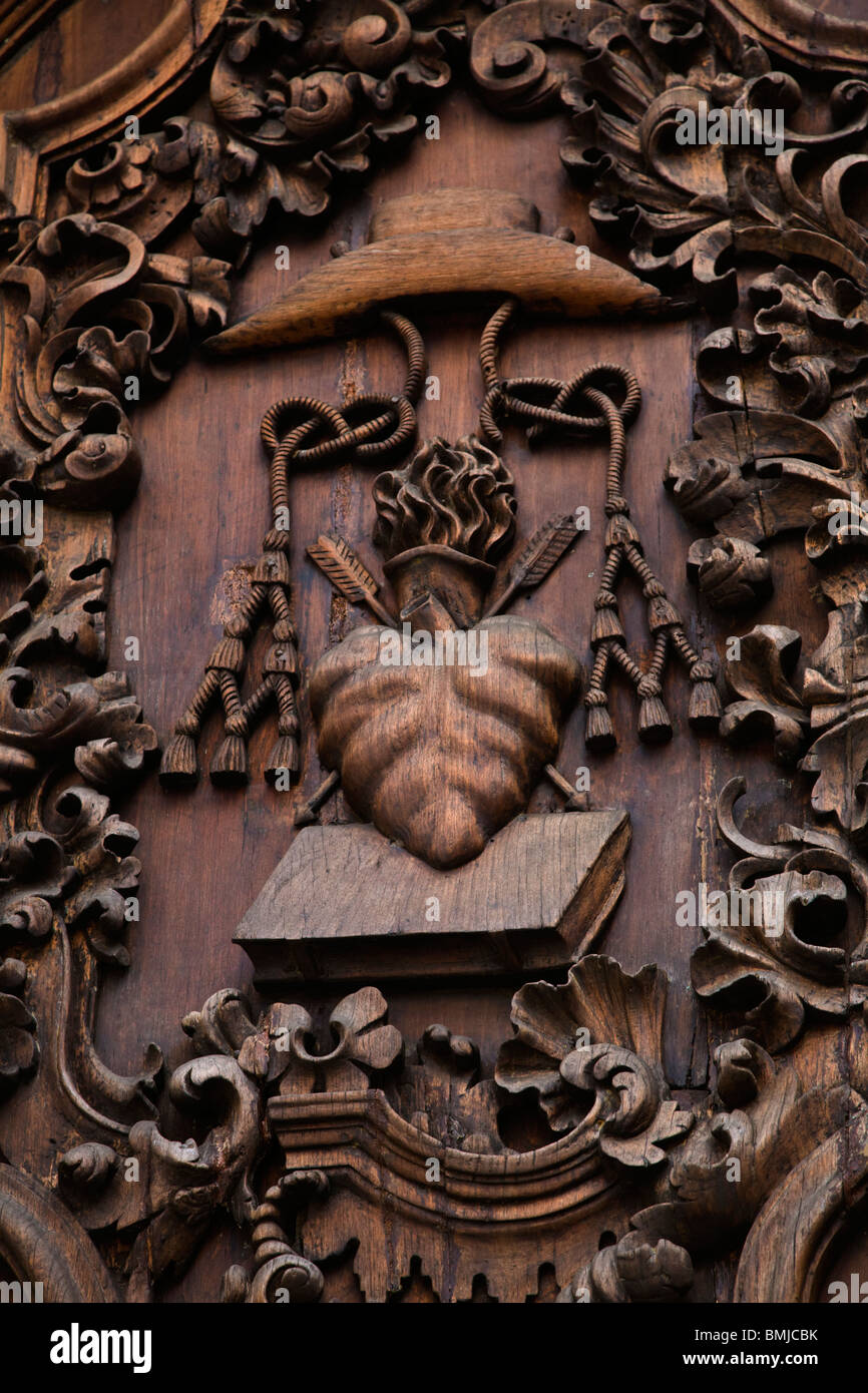 Flaming Heart of Jesus on a wooden door of the SAN AGUSTIN CHURCH,  oldest building in Spanish district of INTRAMUROS - MANILA Stock Photo