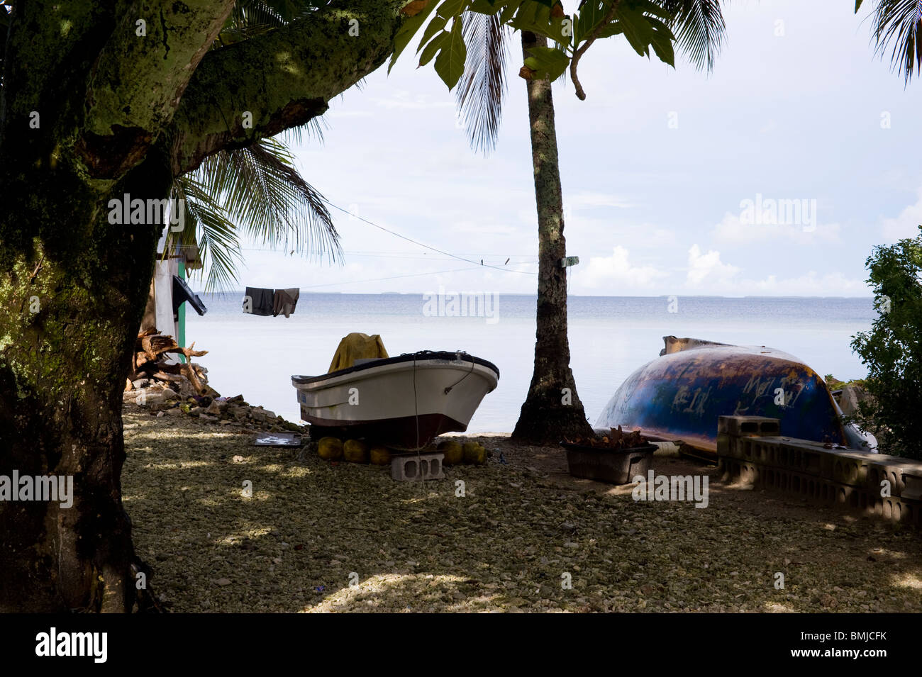 Two boats drawn up in a lagoonside yard in Jabor, Jaluit Atoll