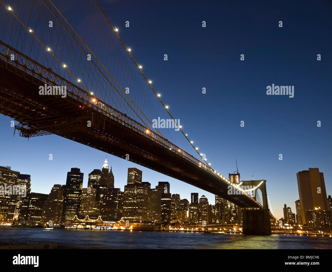 View of the Brooklyn bridge and south Manhattan from Brooklyn at dusk. Stock Photo