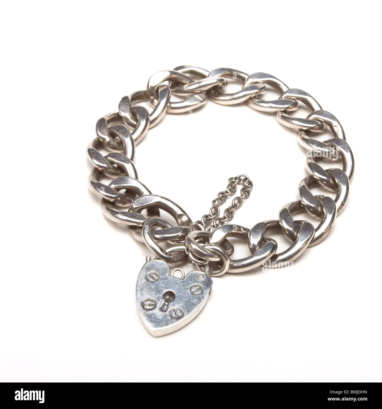 Chunky silver charm bracelet with heart shaped padlock Stock Photo
