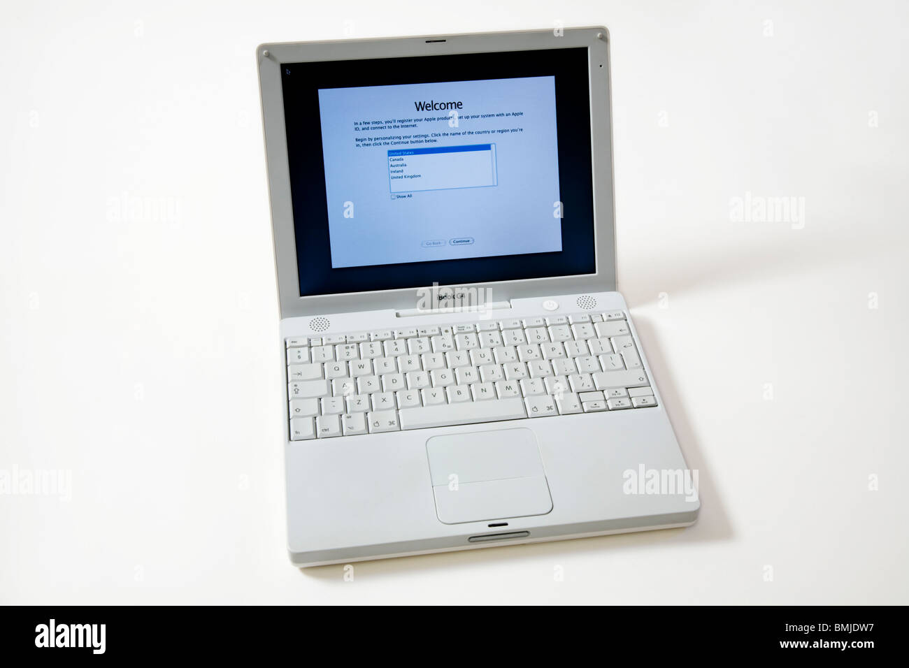 Apple iBook G4 laptop / lap top computer with scrolling TrackPad / trackpad / track pad, start / starting up screen & keyboard. Stock Photo