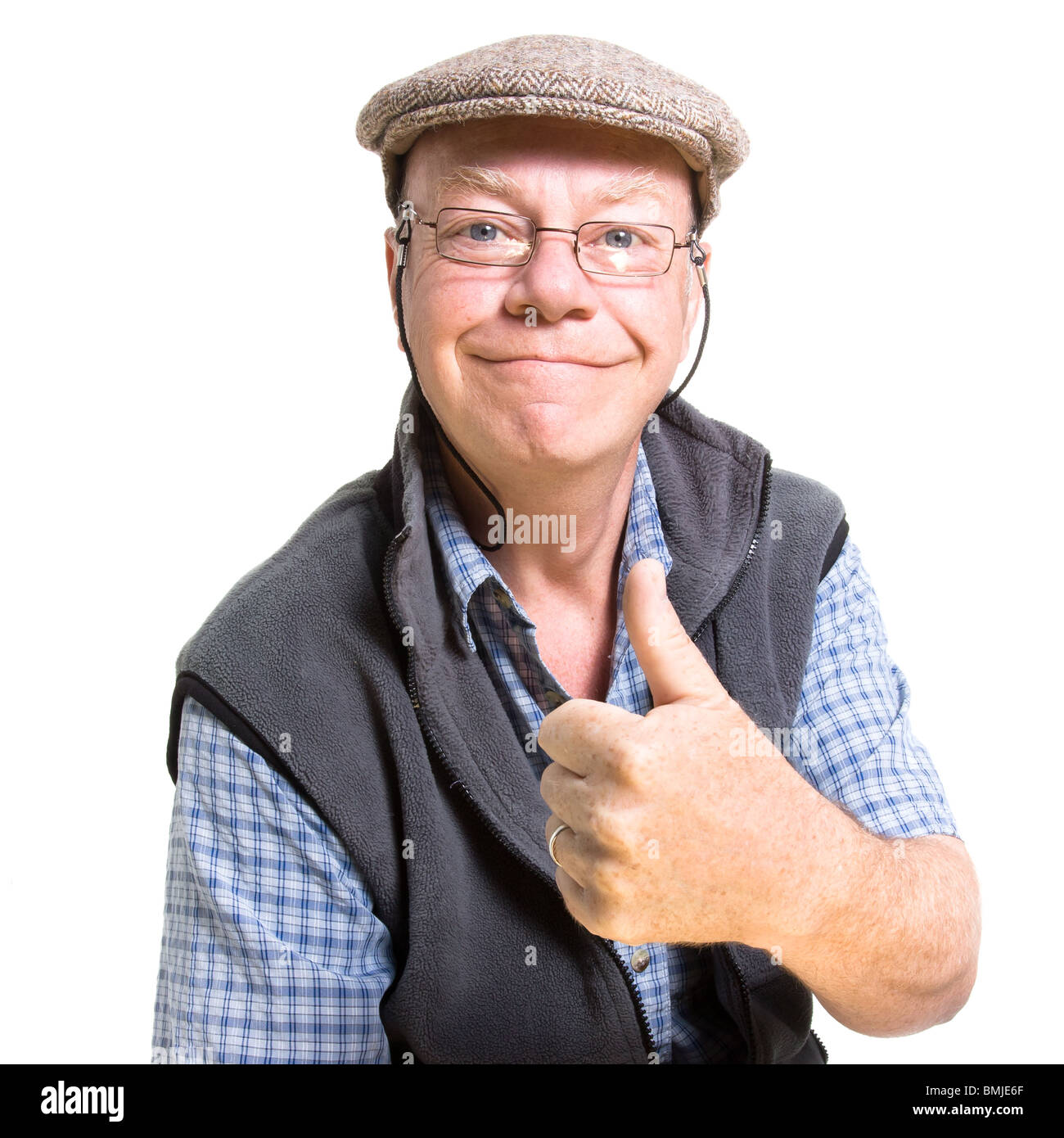 Expressive old man giving thumbs up isolated against white background. Stock Photo